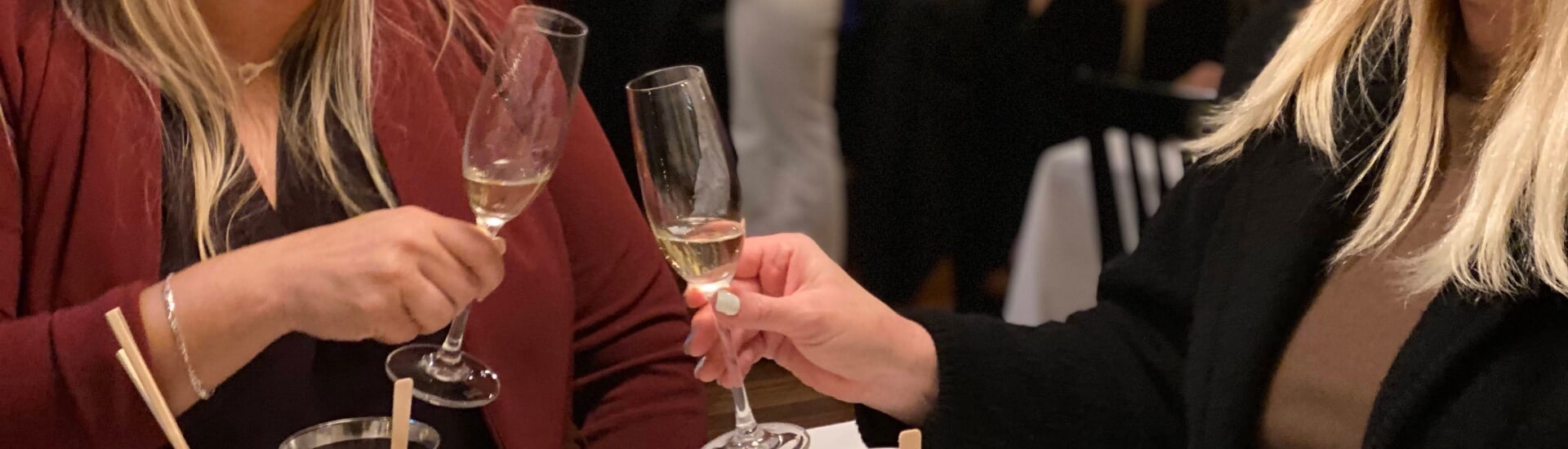 two women toasting with glasses of champagne