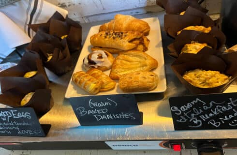 a table with breakfast pastries and muffins