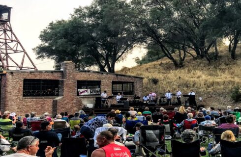 a lot of people around a mine with a band playing music