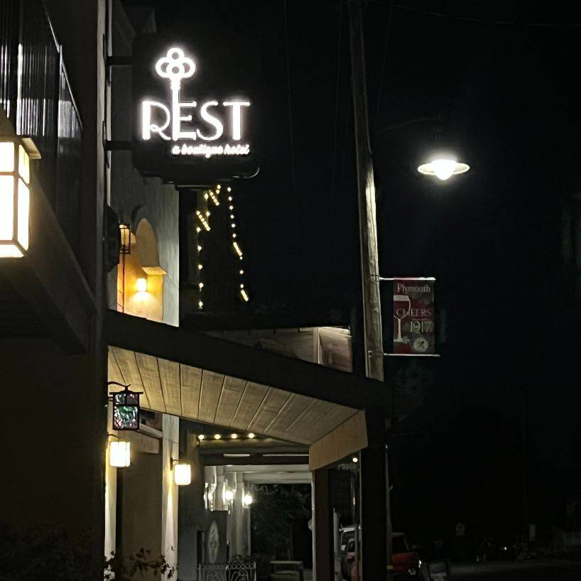 night view of Rest Hotel sign and street lights